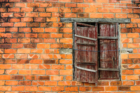 Wooden window on orange brick wallの写真素材