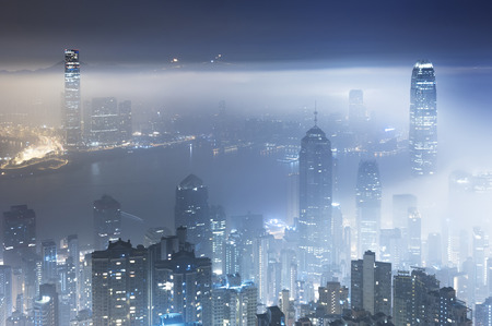 Misty night view of Victoria harbor in Hong Kong cityの写真素材
