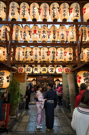 KYOTO, JAPAN - APRIL 07:  Illuminated paper lanterns hanging above the entrance of Nishiki Tenmangu Shrine in Kyoto, Japan on April 07 2016. The shrine is located in the heart of Nishiki food market.のeditorial素材