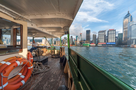 Hong Kong - MAY 25 2013 : Victoria Harbor of Hong Kong, viewed from the deck of Star Ferry. The Star Ferry, or the "Star" Ferry Company, is a passenger ferry service operator and tourist attraction in Hong Kong.のeditorial素材