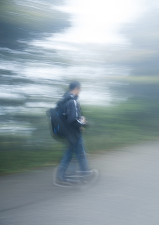 Blurred people walking in natureの写真素材