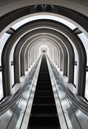Futuristic tunnel and escalator of steel and metal, interior view. Futuristic background, business conceptの写真素材