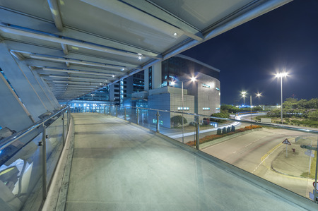 Empty modern pedestrian walkway in midtown at nightの写真素材