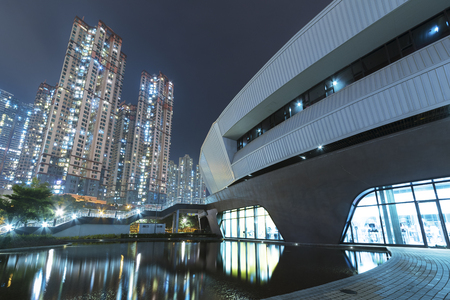 Modern architecture in Park and high rise residential building in Hong Kong city at nightの写真素材