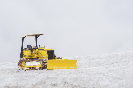 Clearing by the excavator of snow driftsの写真素材