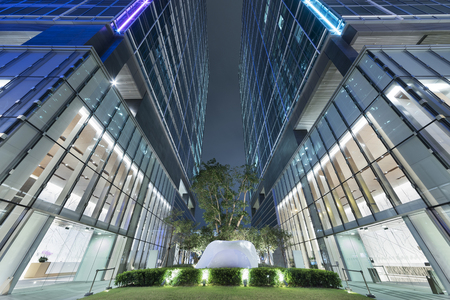 Business office building in Hong Kong city at nightの写真素材