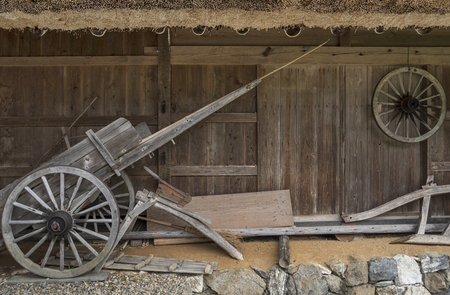 old wooden wheelbarrow in farm house. Autumn harvest backgroundの写真素材