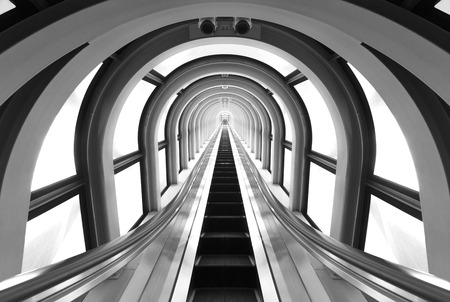Futuristic tunnel and escalator of steel and metal, interior view. Futuristic background, business conceptの写真素材