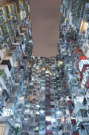 Old residential buildings in Hong Kong city at nightの写真素材