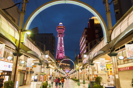 Osaka, Japan - April 13, 2016 : Tsutenkaku Tower in Shinsekai (new world) district at night. Tsutenkaku tower and the area are developed in 1912 with New York and Paris as models.のeditorial素材