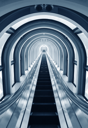 Futuristic tunnel and escalator of steel and metal, interior view. Futuristic background, business conceptの写真素材