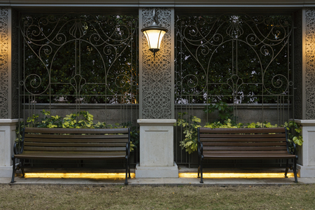Empty wooden seat in garden at nightの写真素材