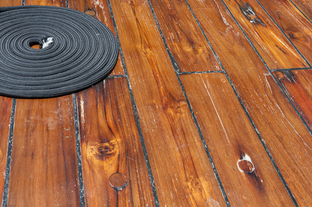 Rope on wooden deck of shipの写真素材