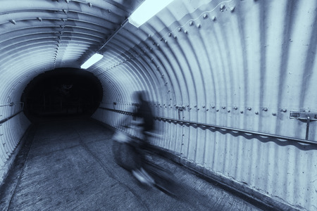 biker riding on bicycle in tunnelの写真素材
