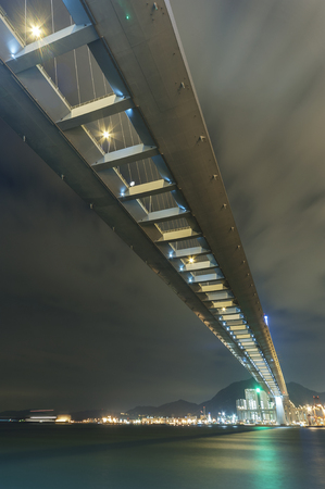 Cutterstone bridge and cargo port in Hong Kong city at nightの写真素材