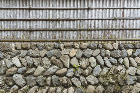 Stone wall and bamboo fence for pattern and backgroundの写真素材