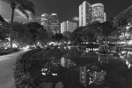 High rise office building and public park in midtown of Hong Kong city at nightの写真素材