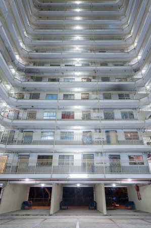 Exterior of high rise residential building of public estate in Hong Kong city at nightのeditorial素材