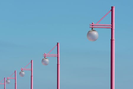 Pink street light with blue sky background