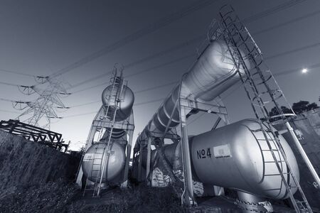 Oil storage tank in chemical factory at night