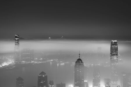 Misty night view of Victoria harbor in Hong Kong cityの写真素材