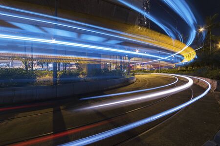 light trails of car on road in downtown at night. Traffic backgroundの写真素材