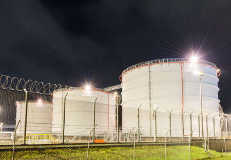 Row of oil tank at night
