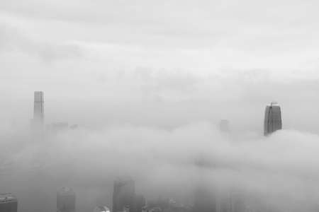 Skyline of Victoria harbor of Hong Kong city in fogの写真素材