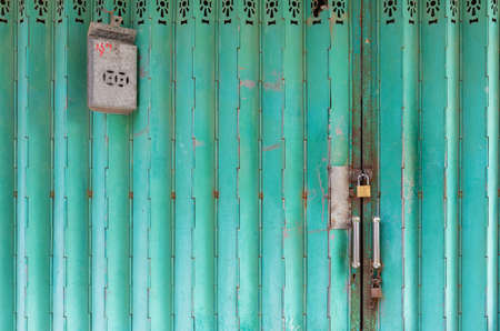 Old mail box on classic foldding metal gate in Hong Kong