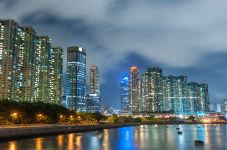 Seaside high rise residential building in Hong Kong city at nightの写真素材