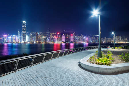 Night scenery of seaside promenade of Victoria harbor of Hong Kong cityの写真素材