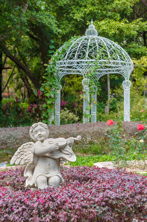 Sculpture of angel and pavilion in Parkの写真素材