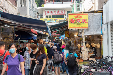 Hong Kong, China - November 05, 2020 : Tourist in the market street in Tai O. Tai O is a popular traditional fishing village on Lantau Island with unique stilt houses in Hong Kong.のeditorial素材