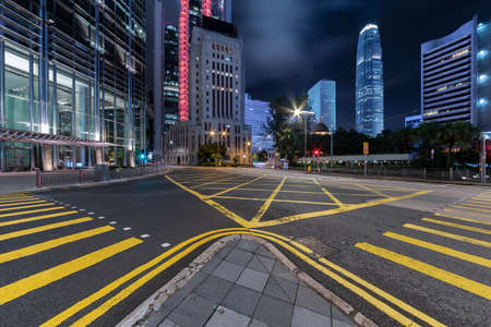 Empty street in downtown district of Hong Kong city at night