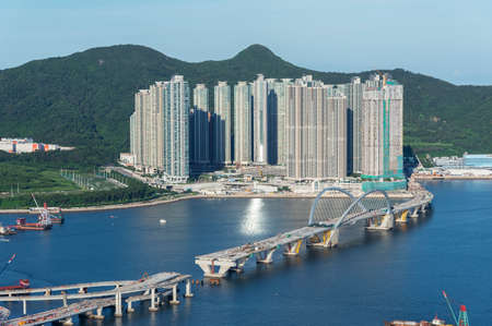Bridge in construction and high rise residential building in Hong Kong cityの写真素材