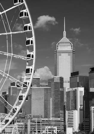 Ferris wheel and skyscraper in downtown district of Hong Kong cityの写真素材
