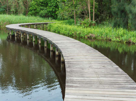 Wooden bridge across river. Natural backgroundの写真素材