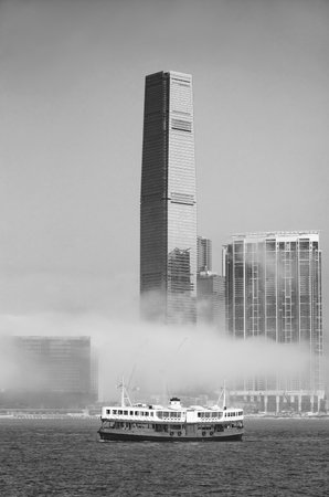 Skyscraper and ferry in Victoria harbor of Hong Kong city