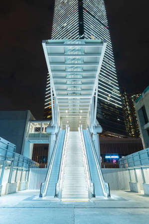 Night scenery of modern escalator and skyscraper in downtown district of Hong Kong cityの写真素材