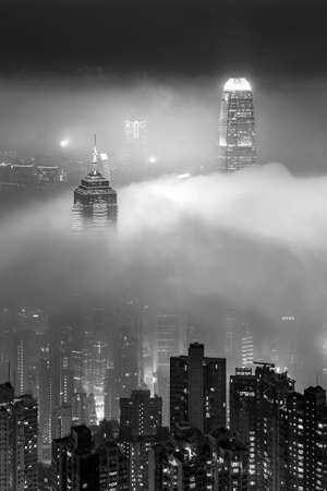 Skyline of Victoria harbor of Hong Kong city in fogの写真素材