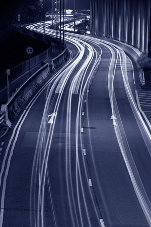 Light trails of traffic on road at night. Transportation background