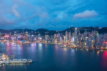 Aerial view of Victoria Harbor of Hong Kong City at duskの写真素材