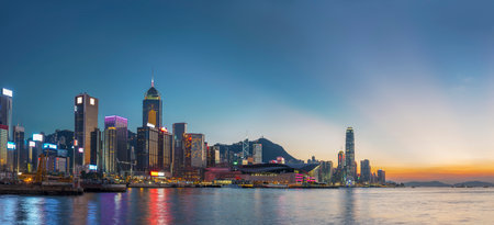Panorama of Victoria harbor of Hong Kong city under sunsetの写真素材