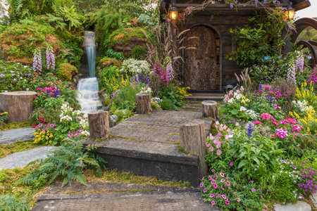 Landscaped backyard of old house with flower gardenの写真素材