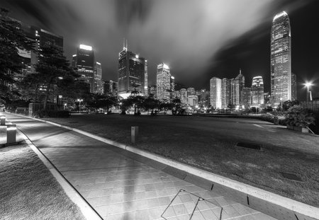 Public park and skyline in downtown district of Hong Kong city at nightの写真素材