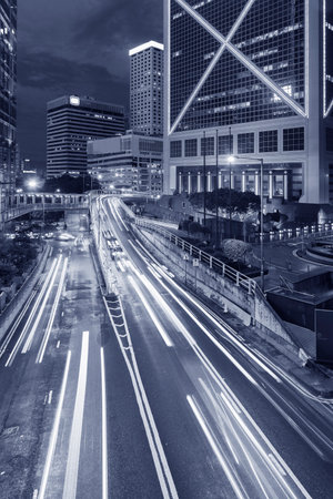 Car traffic in central district of Hong Kong city at nightの写真素材
