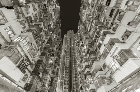 Crowded old and new residential building in Hong Kong city at nightのeditorial素材