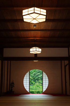 Looking out the green leaves from small round window in Japanese room. Oriental interior backgroundのeditorial素材