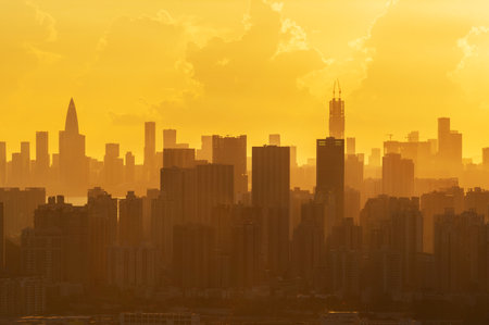 Silhouette of skyline of Shenzhen city, China under sunset. Viewed from Hong Kong borderの写真素材