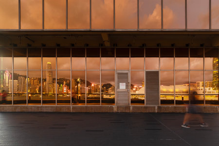 Reflection of skyline of Victoria harbor of Hong Kong city on the exterior of modern architectureの写真素材